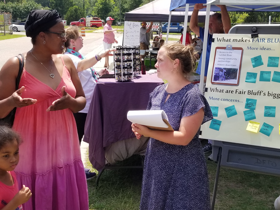 Meredith Burns (right), a graduate student in the Department of City and Regional Planning, met with residents during Fair Bluff’s annual Watermelon Festival, gathering and listening to ideas about what improvements they would like to see to make the town more resilient. Photo by Gavin Smith.