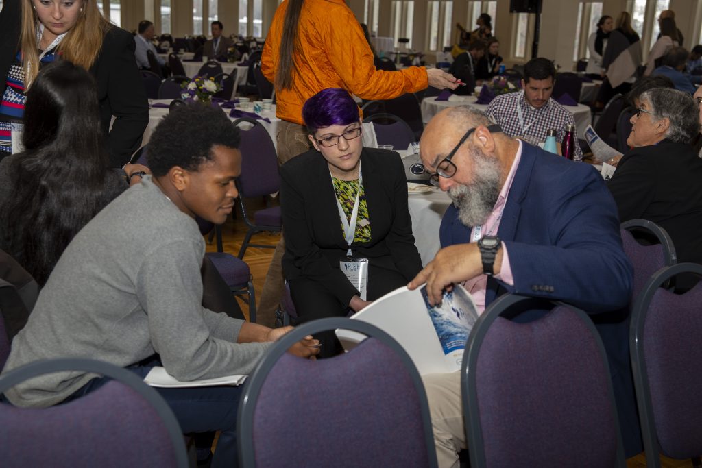 From left: CRC students Alex Halloway of UNC-Chapel Hill and Sarah Lipuma of Duke University discuss presentations with Cecilio Ortiz García, Senior RISE Fellow with the National Council for Science and the Environment. Photo By Brian Busher, University of Albany
